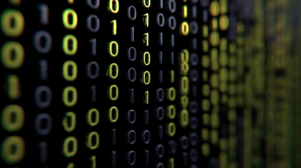 黒バックで黄色の0と1の数字が羅列されている