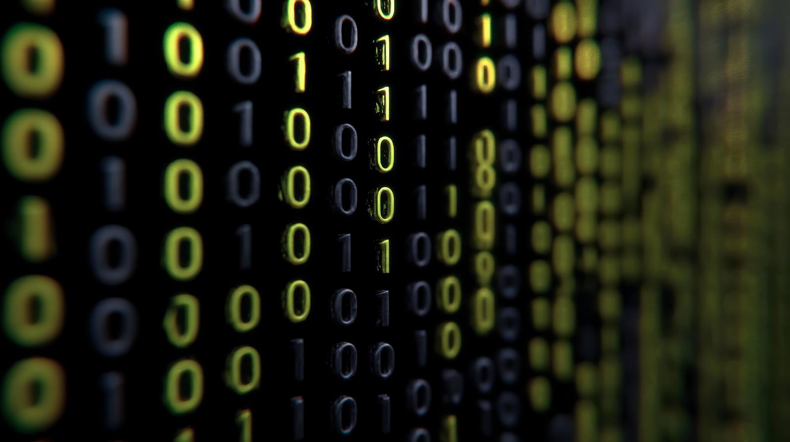 黒バックで黄色の0と1の数字が羅列されている。